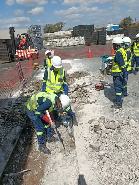 Team breaking and preparing concrete industrial pavement