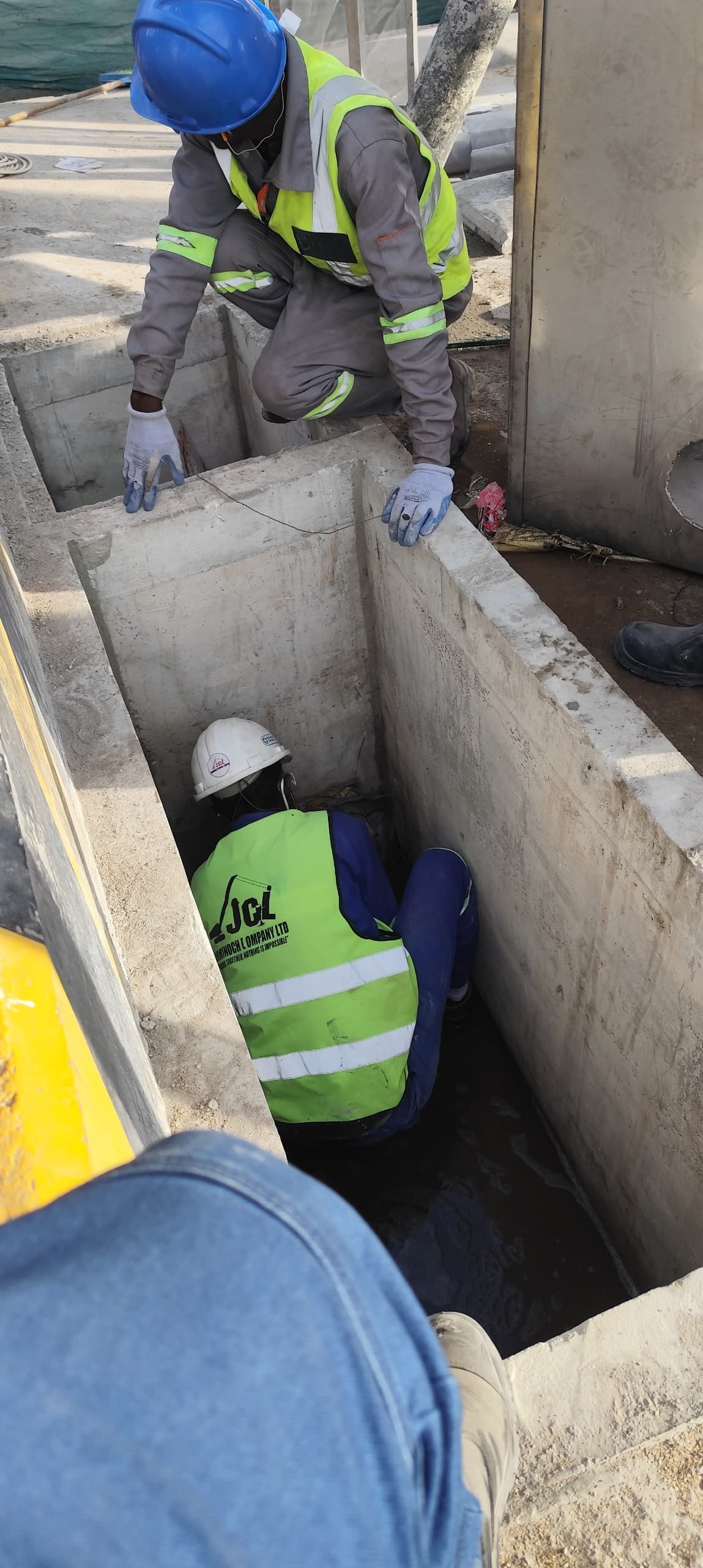 JCL crew working inside a concrete drainage channel