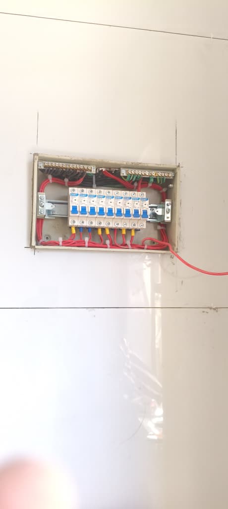 Completed electrical distribution board mounted on an interior wall