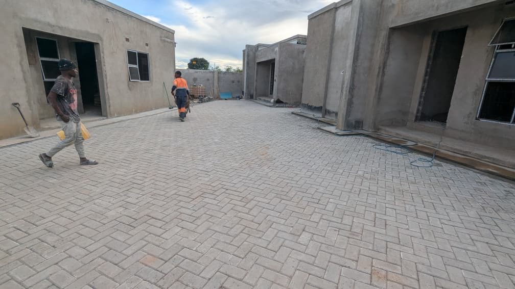 Freshly laid interlocking paved courtyard between completed housing units