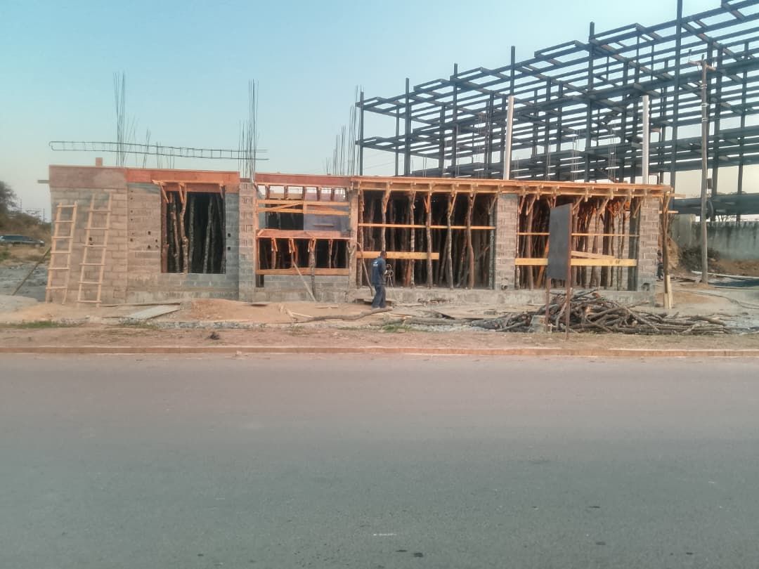 Roadside building wrapped in timber formwork with structural steel frame behind