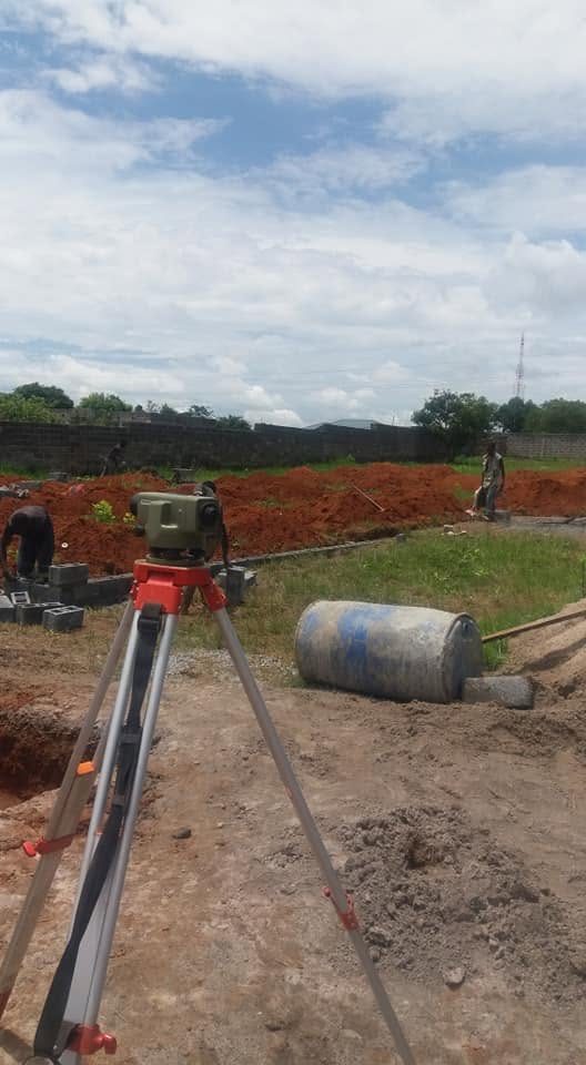 Surveyor taking levels with dumpy level on site