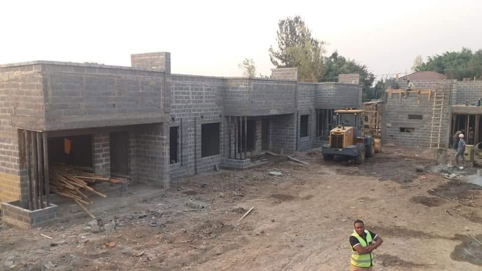 Multiple housing units under blockwork stage with front loader