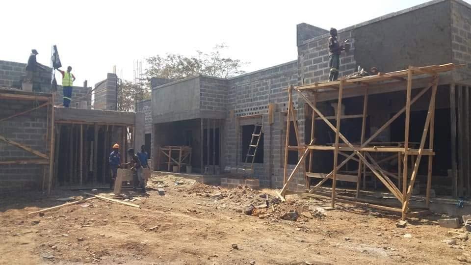 Masons working on scaffolding at housing site